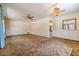 Inviting living room featuring carpet, a ceiling fan, and a unique light fixture at 309 Kenmore Rd, Brandon, FL 33511