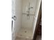 Bright shower features tile walls, shower head, grab bars, and a built-in shelf at 309 Kenmore Rd, Brandon, FL 33511