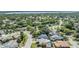 Aerial shot showcases the neighborhood with lush greenery and a glimpse of the nearby lake at 3105 Avocet Pl, Safety Harbor, FL 34695