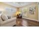 Cozy bedroom with a comfortable sofa, wood floors and bright windows, creating a relaxing atmosphere at 3105 Avocet Pl, Safety Harbor, FL 34695