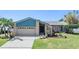 Charming single-story home with a stone facade, well-manicured lawn, and a two-car garage at 3105 Avocet Pl, Safety Harbor, FL 34695
