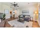 Bright living room featuring hardwood floors, modern furnishings, and a ceiling fan at 3105 Avocet Pl, Safety Harbor, FL 34695