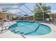 Beautiful pool area with screened enclosure, mature landscaping, and outdoor seating at 3105 Avocet Pl, Safety Harbor, FL 34695