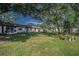Serene backyard with verdant lawn and shade trees, providing a peaceful outdoor retreat at 3126 Highlands Blvd # 3126, Palm Harbor, FL 34684