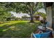 Inviting backyard features lush lawn and mature trees, perfect for outdoor living and relaxation at 3126 Highlands Blvd # 3126, Palm Harbor, FL 34684