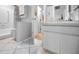 Neutral bathroom with white tiled floors, cabinet, and shower/tub combo at 3126 Highlands Blvd # 3126, Palm Harbor, FL 34684