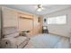 Bedroom featuring hardwood floors, a ceiling fan, and built-in cabinets at 3126 Highlands Blvd # 3126, Palm Harbor, FL 34684