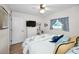 Serene bedroom featuring ceiling fan, light-wood floors, chest of drawers, and a view of the window at 3126 Highlands Blvd # 3126, Palm Harbor, FL 34684