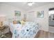 Comfortable bedroom with neutral decor and fan, including a view to the ensuite bathroom and closet at 3126 Highlands Blvd # 3126, Palm Harbor, FL 34684