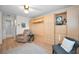Bedroom featuring hardwood floors, ceiling fan, and built-in cabinets at 3126 Highlands Blvd # 3126, Palm Harbor, FL 34684