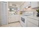 Well-maintained kitchen area with a pass-through window and white cabinetry for ample storage at 3126 Highlands Blvd # 3126, Palm Harbor, FL 34684