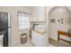 Functional kitchenette area equipped with microwave, white cabinets, and natural lighting from the window at 3126 Highlands Blvd # 3126, Palm Harbor, FL 34684