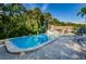 Luxurious swimming pool and patio area with chairs, complemented by lush landscaping for a resort-like experience at 3126 Highlands Blvd # 3126, Palm Harbor, FL 34684