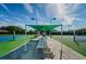 Beautiful tennis court with a shaded seating area, providing a comfortable spot to relax and enjoy the game at 3126 Highlands Blvd # 3126, Palm Harbor, FL 34684