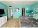 A bright and inviting bedroom shows a comfortable queen bed, neutral carpet, and en suite bathroom at 320 Medallion Blvd # G, Madeira Beach, FL 33708