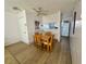 Cozy dining area with a ceiling fan and view of the kitchen through an open pass-through at 320 Medallion Blvd # G, Madeira Beach, FL 33708