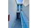 Building exterior showing stairs leading to the units above, including blue railings and door at 320 Medallion Blvd # G, Madeira Beach, FL 33708