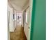 Hallway displaying neutral walls and carpet leading to the bedroom and other rooms at 320 Medallion Blvd # G, Madeira Beach, FL 33708