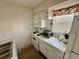 Efficient kitchen with white cabinets, appliances, and a window above the sink at 320 Medallion Blvd # G, Madeira Beach, FL 33708