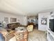 Inviting living room with wicker furniture, decor, and a view into the dining and kitchen area at 320 Medallion Blvd # G, Madeira Beach, FL 33708