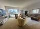 Cozy living room with wicker furniture, large windows, and a glimpse of the outdoor scenery at 320 Medallion Blvd # G, Madeira Beach, FL 33708