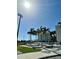 A recreation center with well-maintained landscaping, a nearby sports field, and palm trees at 320 Medallion Blvd # G, Madeira Beach, FL 33708