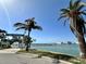 Enjoy waterfront views with palm trees and a glimpse of the pier in this scenic shot at 320 Medallion Blvd # G, Madeira Beach, FL 33708