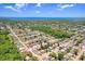 Expansive aerial view showcasing the neighborhood, mature trees, and proximity to the water at 3247 Kimberly Oaks Dr, Holiday, FL 34691
