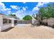 Fenced backyard with gravel, small patio, storage shed, and mature trees at 3247 Kimberly Oaks Dr, Holiday, FL 34691