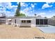 Cozy backyard featuring gravel, patio, and a bright exterior under a blue sky at 3247 Kimberly Oaks Dr, Holiday, FL 34691