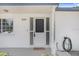 Charming front entrance with a decorative door, white trim, and brick accents at 3247 Kimberly Oaks Dr, Holiday, FL 34691