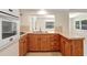 Well-equipped kitchen with wood cabinetry and view of dining area at 3247 Kimberly Oaks Dr, Holiday, FL 34691