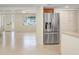 Modern kitchen featuring stainless steel refrigerator and convenient access to living area at 3247 Kimberly Oaks Dr, Holiday, FL 34691