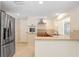 Kitchen area showcasing stainless steel refrigerator, built-in oven and range at 3247 Kimberly Oaks Dr, Holiday, FL 34691
