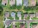 An aerial view of a neighborhood featuring well-maintained homes and neatly manicured lawns at 3406 Regner Dr, Plant City, FL 33566