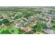 Aerial view of a home in a planned community featuring mature trees and well-kept lawns at 3406 Regner Dr, Plant City, FL 33566