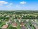 An aerial view of a home nestled in a lush, green neighborhood with mature trees at 3406 Regner Dr, Plant City, FL 33566