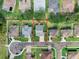 Aerial view of a property with a well-maintained lawn, surrounded by neighborhood homes at 3406 Regner Dr, Plant City, FL 33566