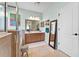 Bright bathroom with double sinks, large vanity, soaking tub, frameless glass shower and a separate standing mirror at 3406 Regner Dr, Plant City, FL 33566