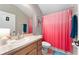 Functional bathroom featuring a shower-tub combo, framed mirror, single sink vanity and decorative accents at 3406 Regner Dr, Plant City, FL 33566