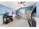 Comfortable bedroom with blue walls, modern workspace, ample natural light and a ceiling fan at 3406 Regner Dr, Plant City, FL 33566