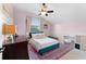 Inviting bedroom with soft pink walls, large window, plush bed, modern desk, and stylish decor at 3406 Regner Dr, Plant City, FL 33566