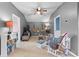 Cozy, carpeted bonus room with ceiling fan, entertainment center, comfortable seating, and neutral decor at 3406 Regner Dr, Plant City, FL 33566
