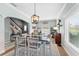 Dining room with a view of the staircase and window, featuring stylish decor and neutral tones at 3406 Regner Dr, Plant City, FL 33566