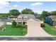 Charming home featuring a three-car garage, brick driveway, and well-manicured landscaping at 3406 Regner Dr, Plant City, FL 33566