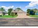Charming home with well-maintained lawn, mature trees, and a brick-paved driveway at 3406 Regner Dr, Plant City, FL 33566