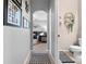 Hallway with decoratively adorned walls that lead to the living room and bathroom at 3406 Regner Dr, Plant City, FL 33566