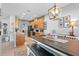 Kitchen and dining area featuring oak cabinets, stainless appliances, and a table with bench seating at 3406 Regner Dr, Plant City, FL 33566
