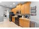 Bright kitchen with modern stainless steel appliances, wooden cabinets, and tiled flooring at 3406 Regner Dr, Plant City, FL 33566