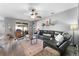 Spacious living room with a comfortable black sectional sofa, ceiling fan, and sliding glass doors at 3406 Regner Dr, Plant City, FL 33566